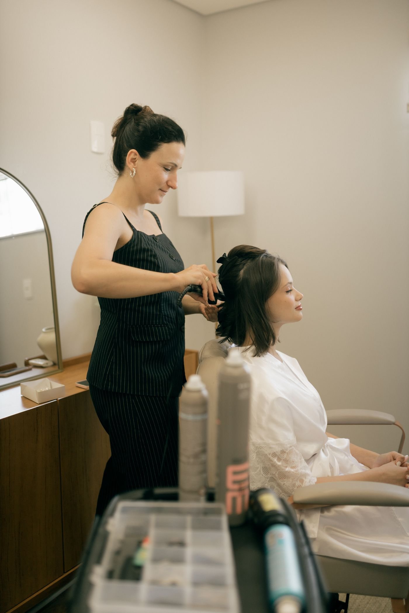 Stylist creating a polished finish for a client